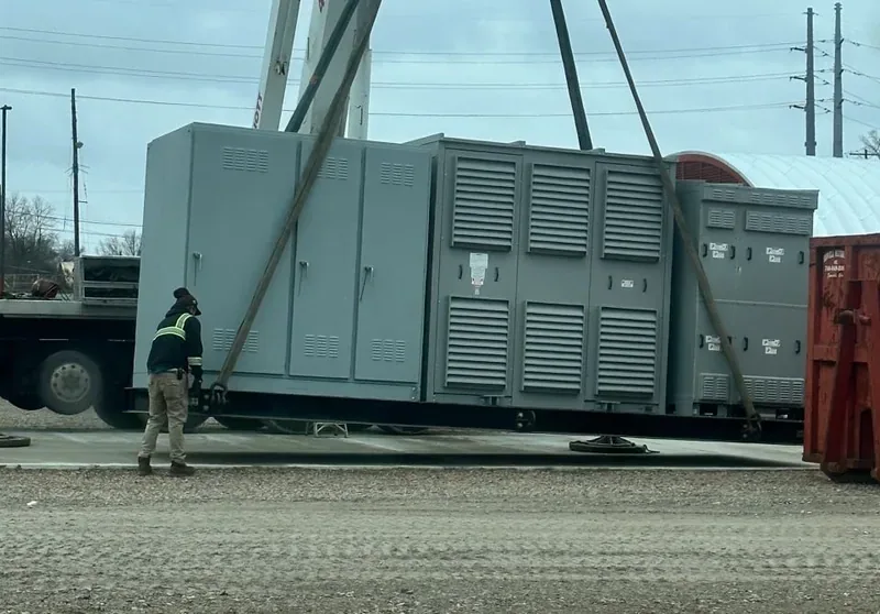 Crane setting a large diesel generator set in place — Austin, TX