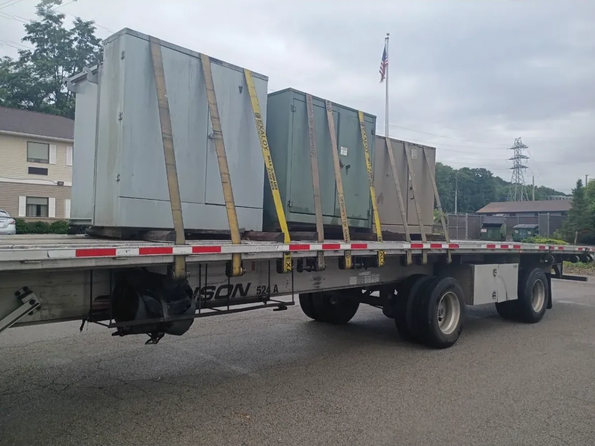 Wrapped and braced switchgear sections on a flatbed