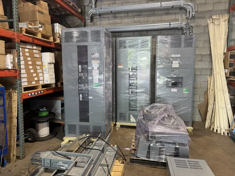 Panelboard and crated electrical parts in a warehouse — Tulsa, OK